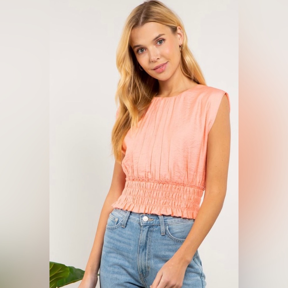 Peach silk like banded bottom. Button on top on back shirt